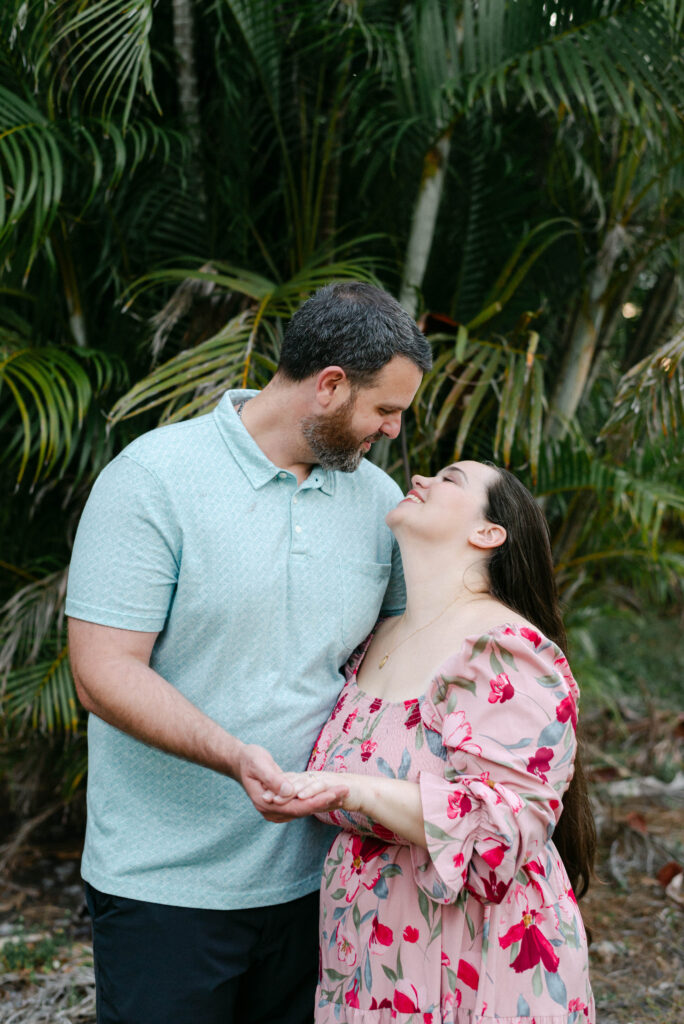 Hands intertwined after surprise engagement with Florida backyard in background