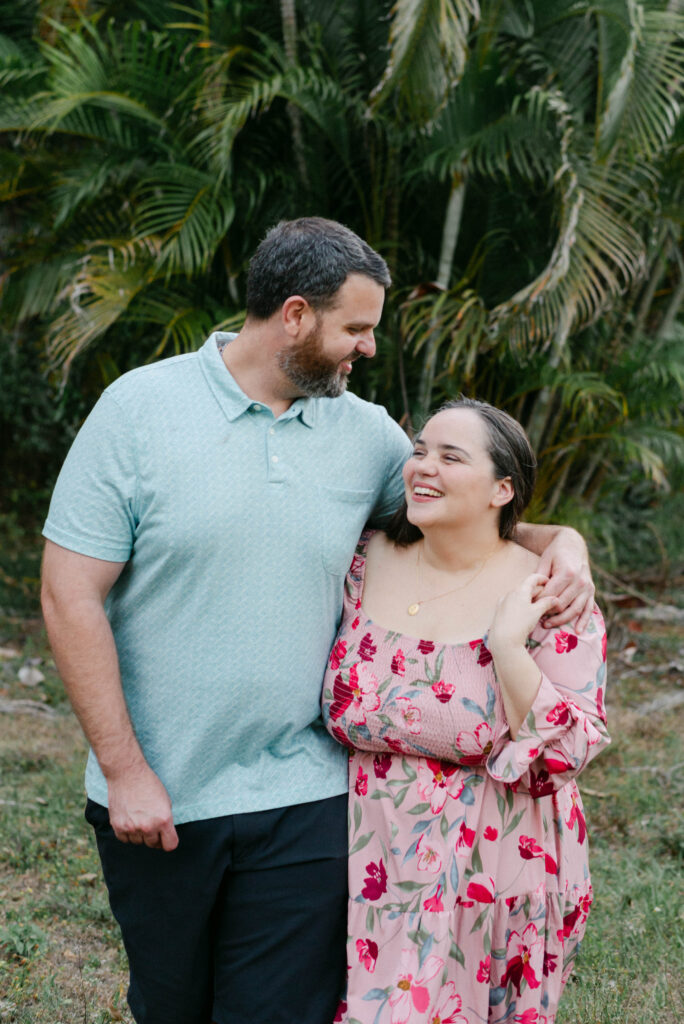Couple walking together through backyard after saying yes in West Palm Beach