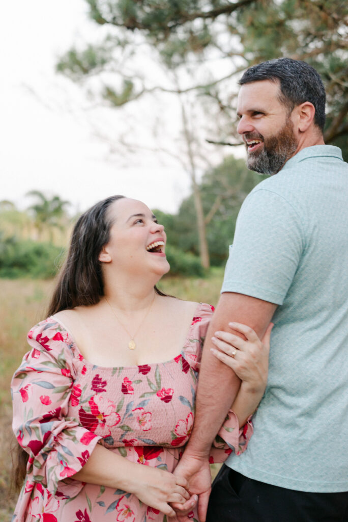 Natural engagement photo of couple embracing during surprise proposal in West Palm Beach