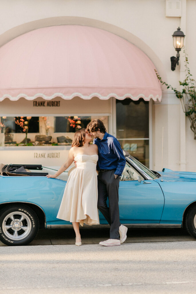 Vintage convertible parked along iconic Palm Beach architecture