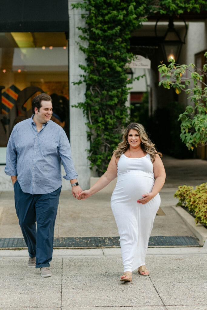 couple walking together through worth avenue palm beach