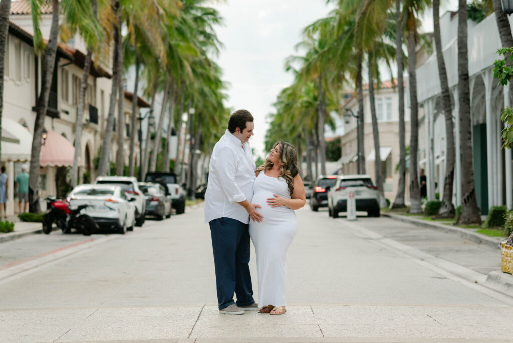 Candid laughter between couple during maternity shoot