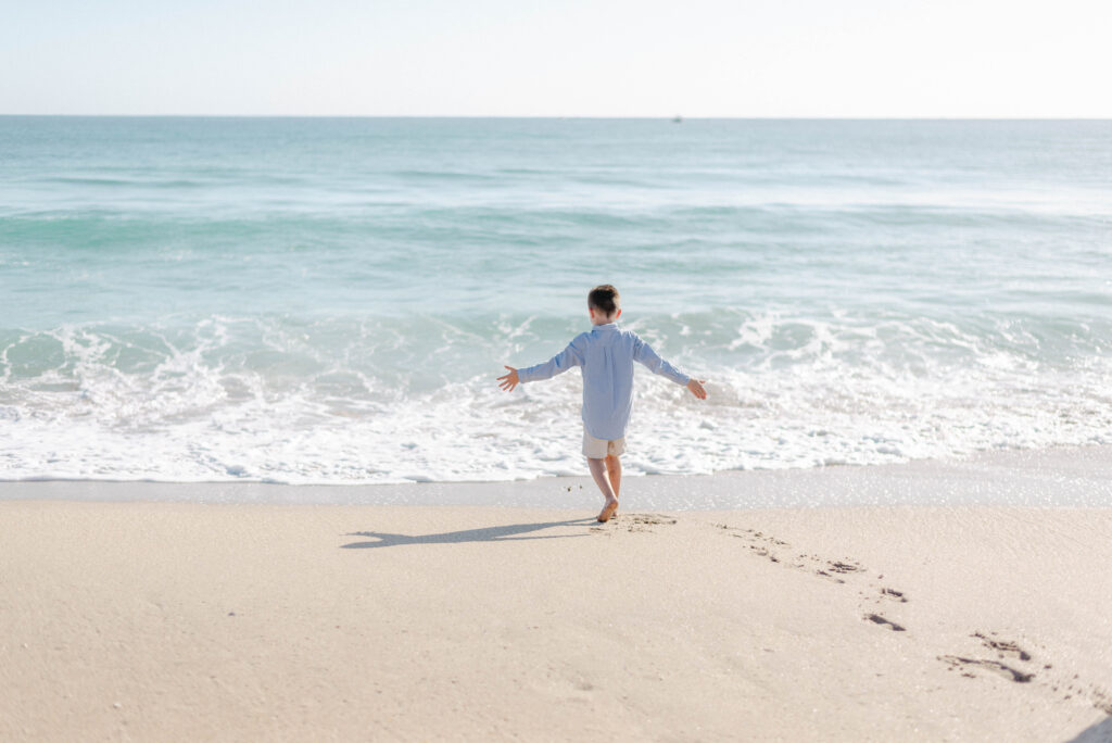 Kids running freely on the beach during relaxed family shoot