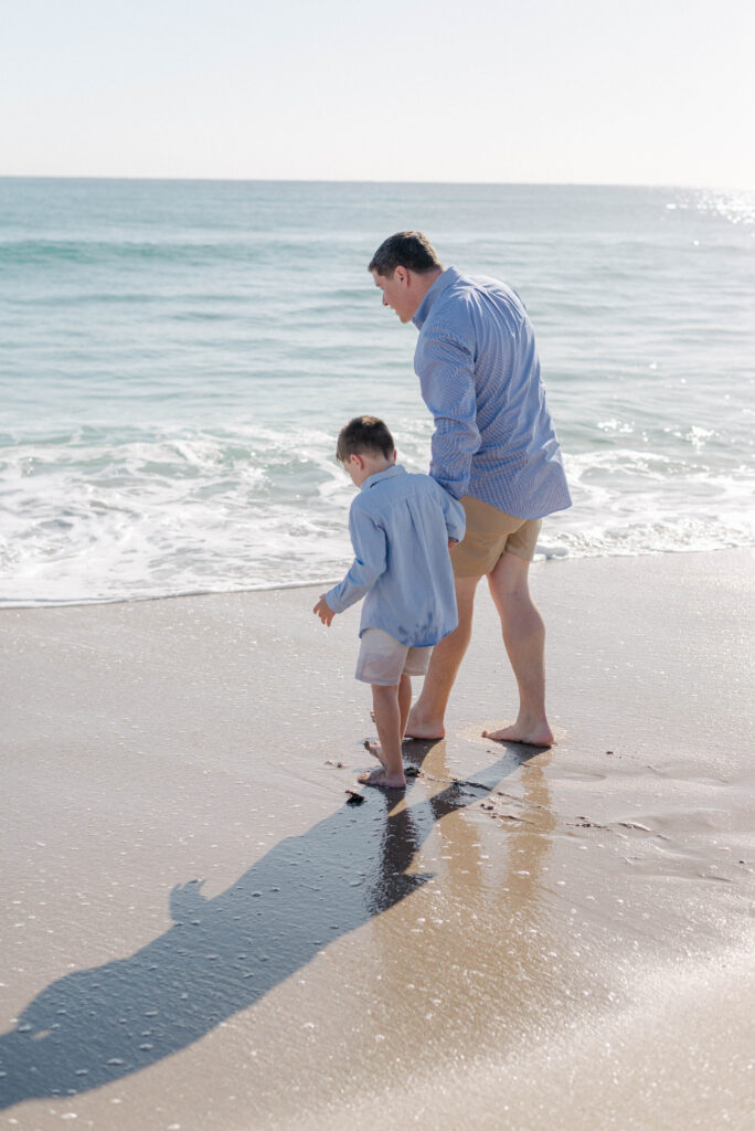 Young boy laughing with his dad during candid family photo
