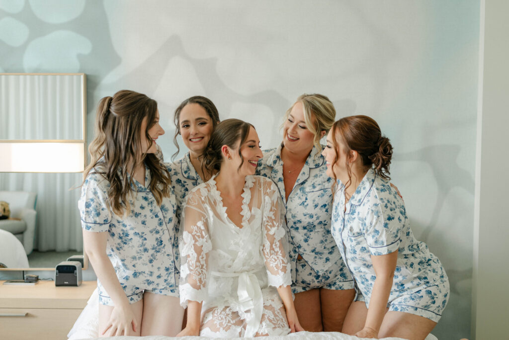 Bride laughing with bridesmaids in robes at Courtyard Delray Beach hotel
