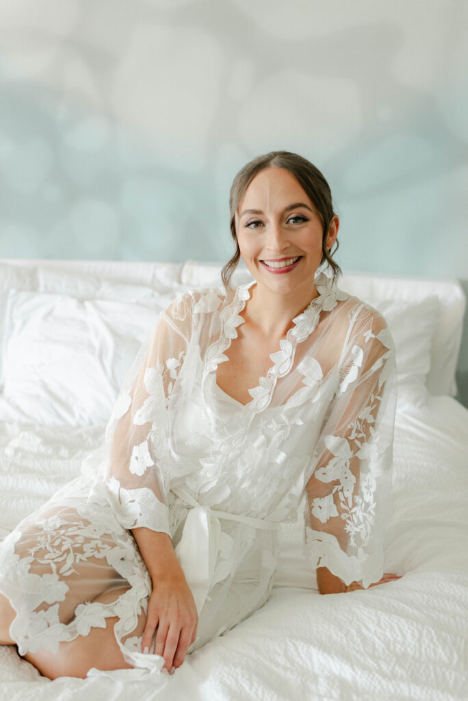 bride smiling in her robe at the courtyard delray beach hotel
