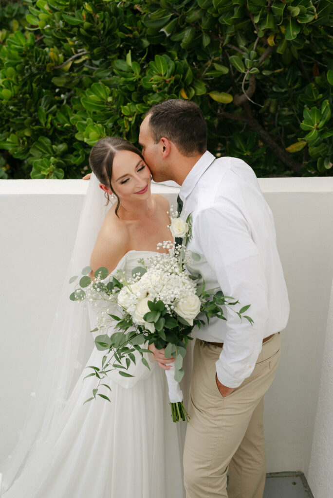 bride and groom softly smiling on the steps