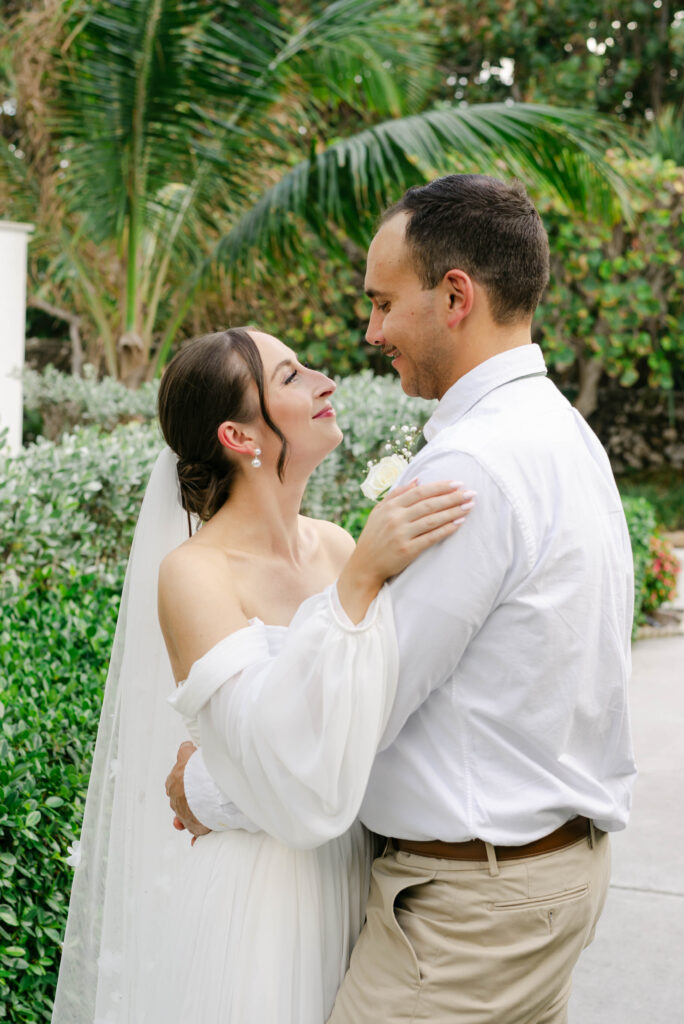 bride and groom giving a soft embrace before walking to the water