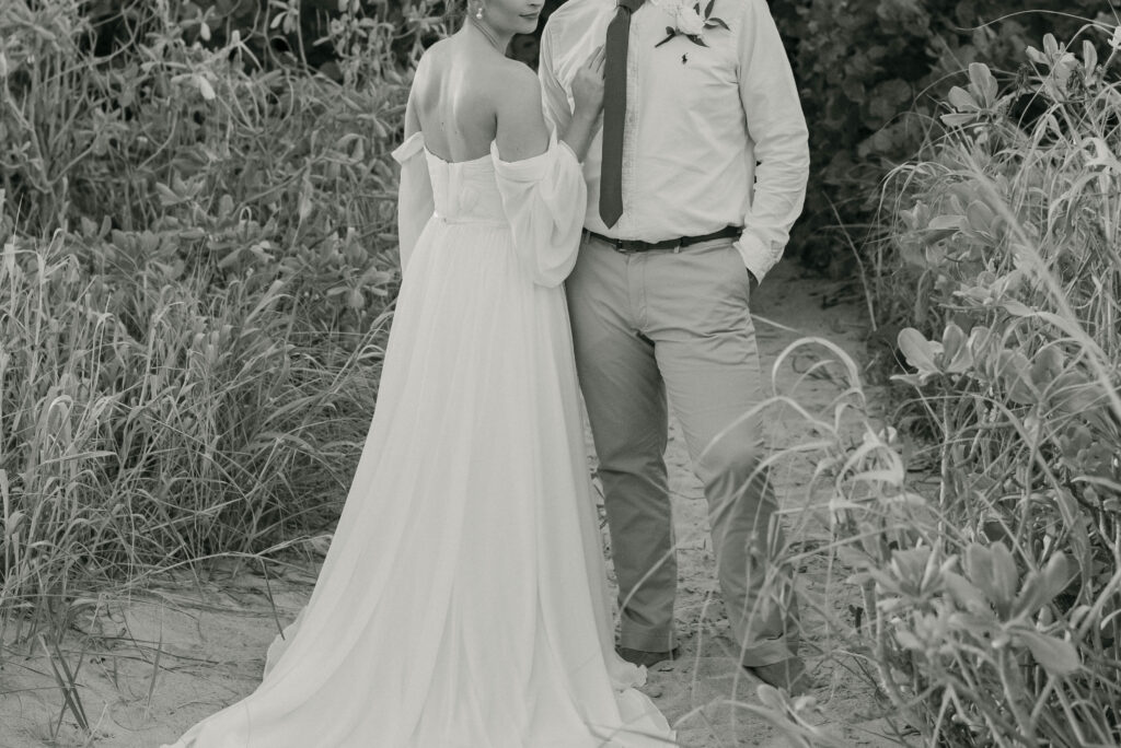 Detail shot of bridal attire with beach florals and textured neutrals