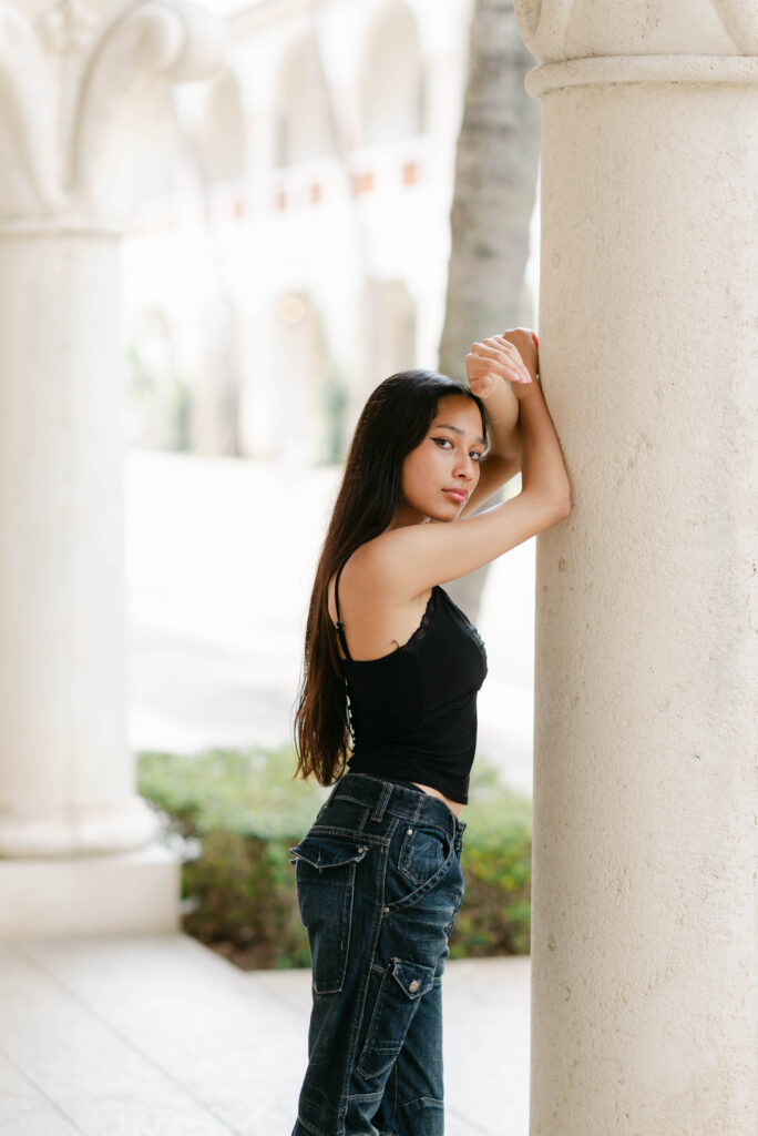 Editorial portrait of model leaning against pillar in Palm Beach