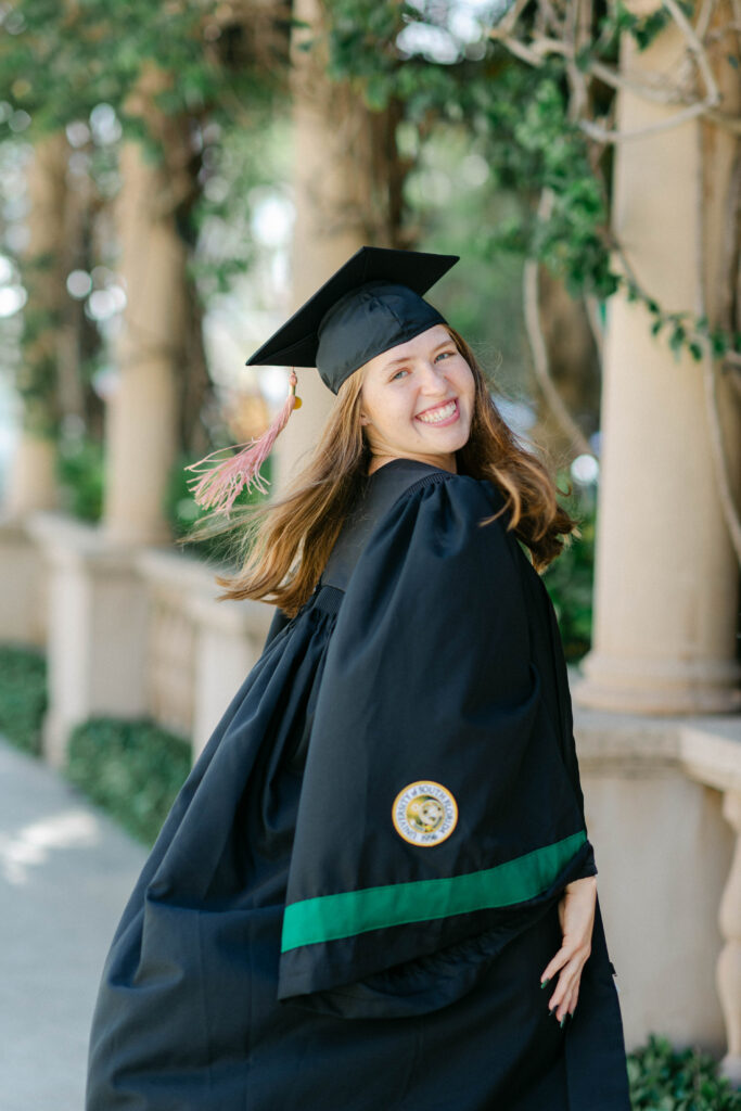 Palm Beach Island grad tossing hair and laughing during golden hour