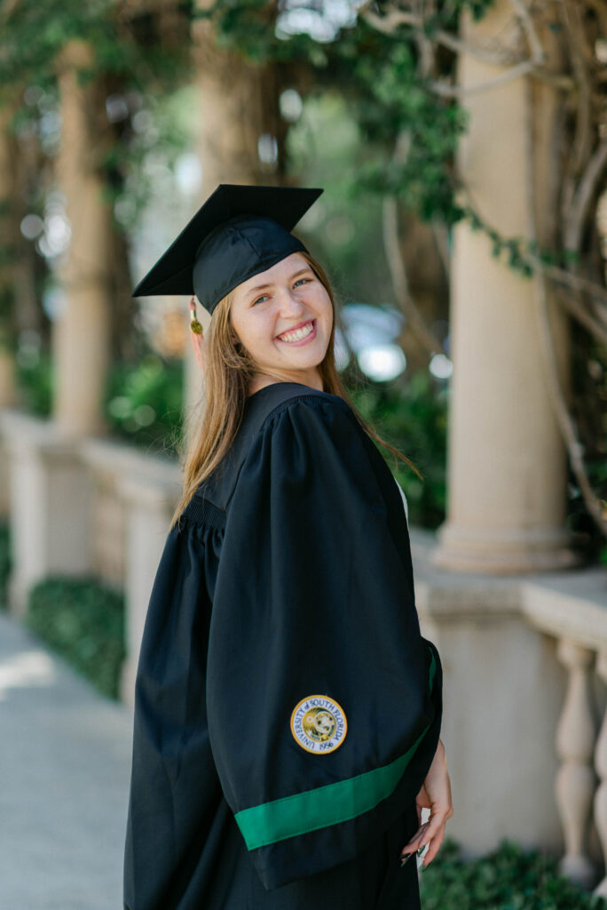 Sunlit portrait of graduate in Palm Beach’s iconic breezeway