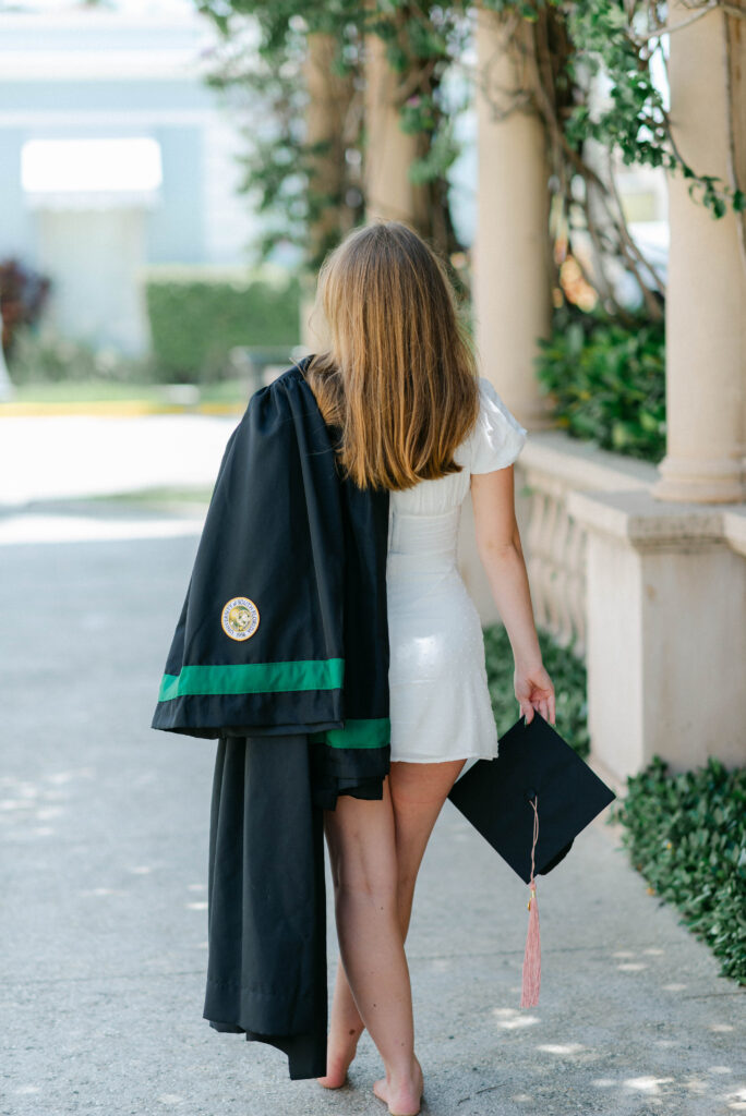 Palm Beach grad walking barefoot on Worth Avenue during sunset photo session