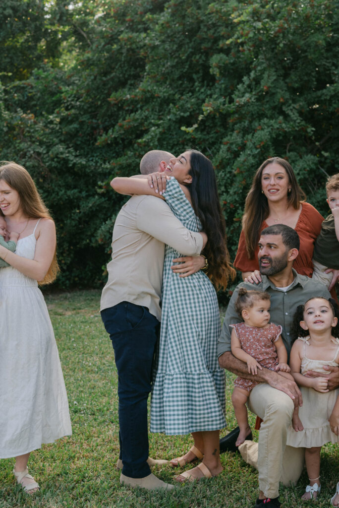 Couple hugging during surprise proposal at backyard family session in Ocala Florida