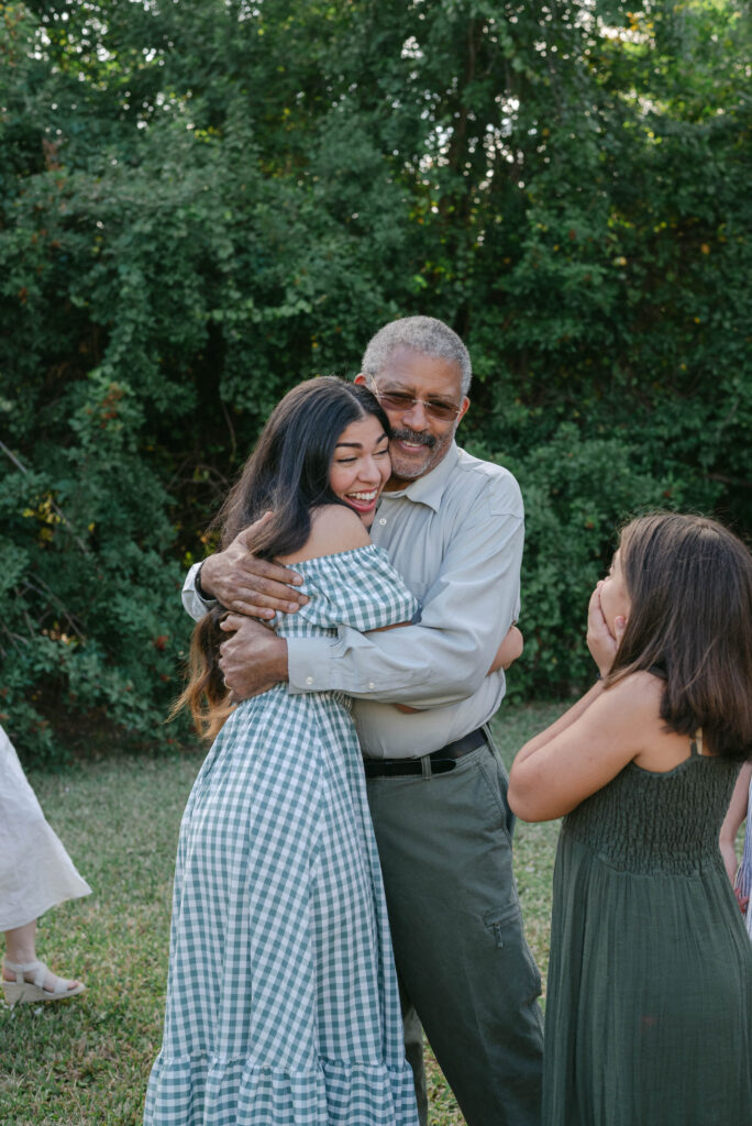 Family celebrating surprise proposal during outdoor family session in Ocala