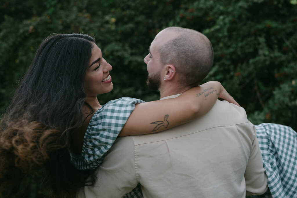 Groom holding bride in his arms after their backyard proposal