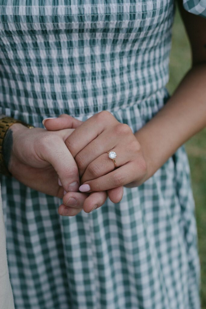 Close up image of the engagement ring moments after a backyard proposal