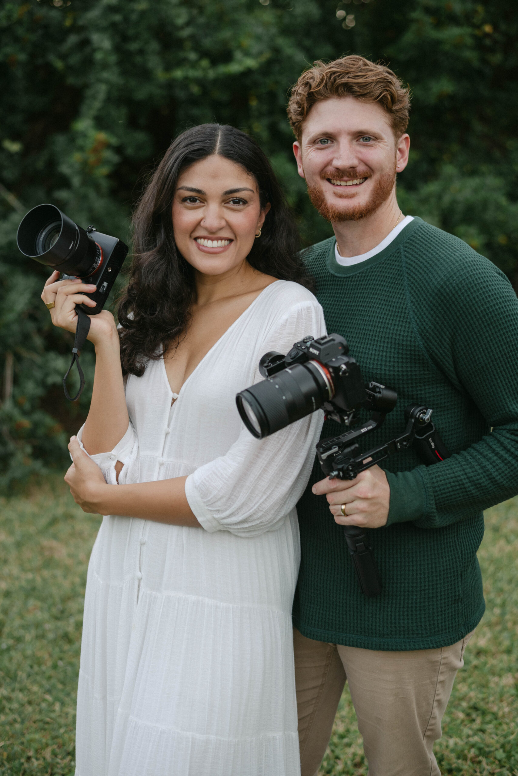 Happy photography duo smiling with cameras, Faithful Media Co Ocala wedding photographer and videographer team