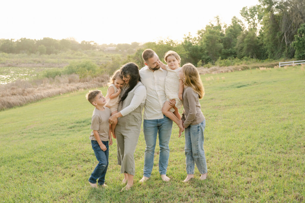 young family playing in a grassy field in Ocala Florida