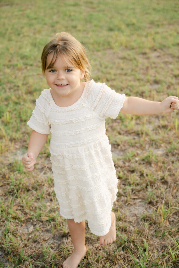 little girl dancing in an ocala field during family photos