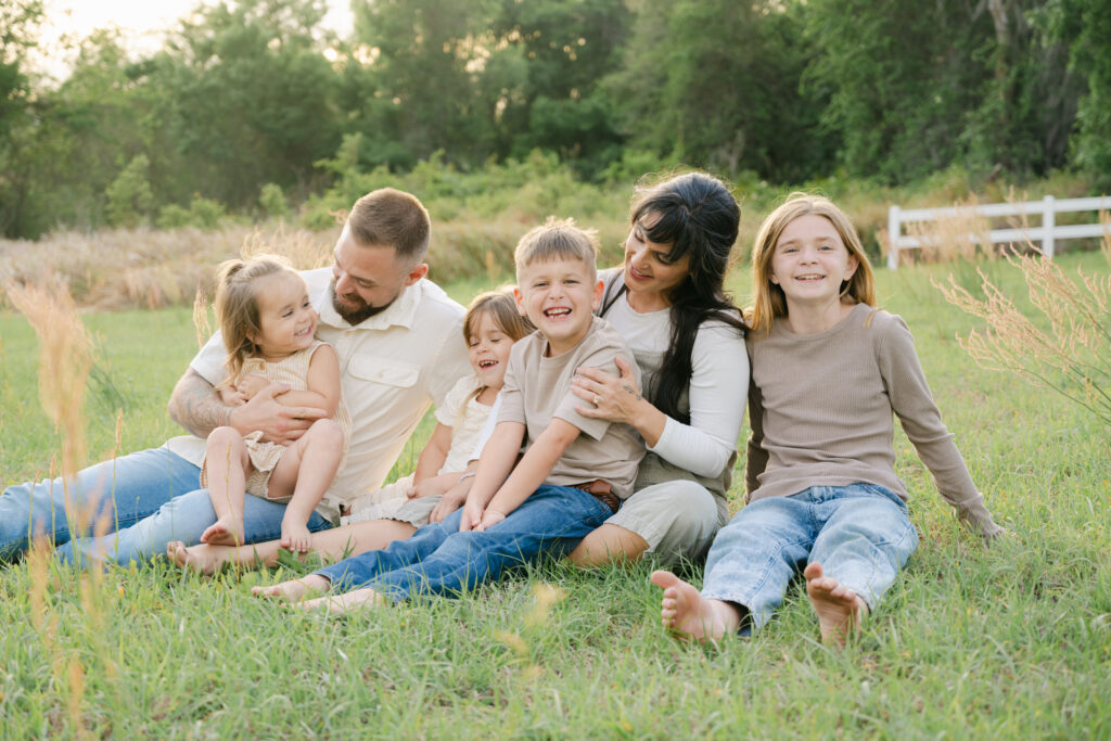 large young family smiling and interacting in a natural family session in ocala